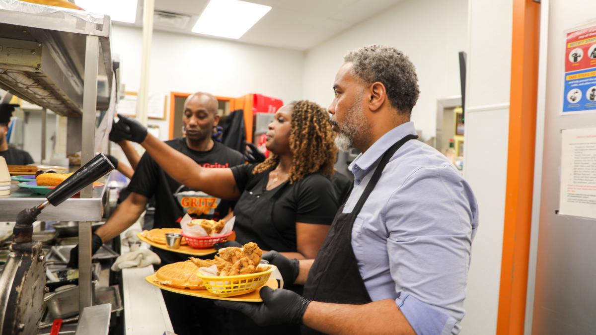 Congressman Horsford Holding a plate of food at Gritz Cafe