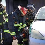 Congressman Horsford dressed as a firefighter using the "jaws of life" 