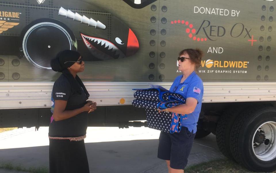 Kelley Guidry accepting a quilt from Quilt of Valor's Louise Davenport